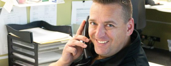 Sadleirs employee answering phone with friendly expression